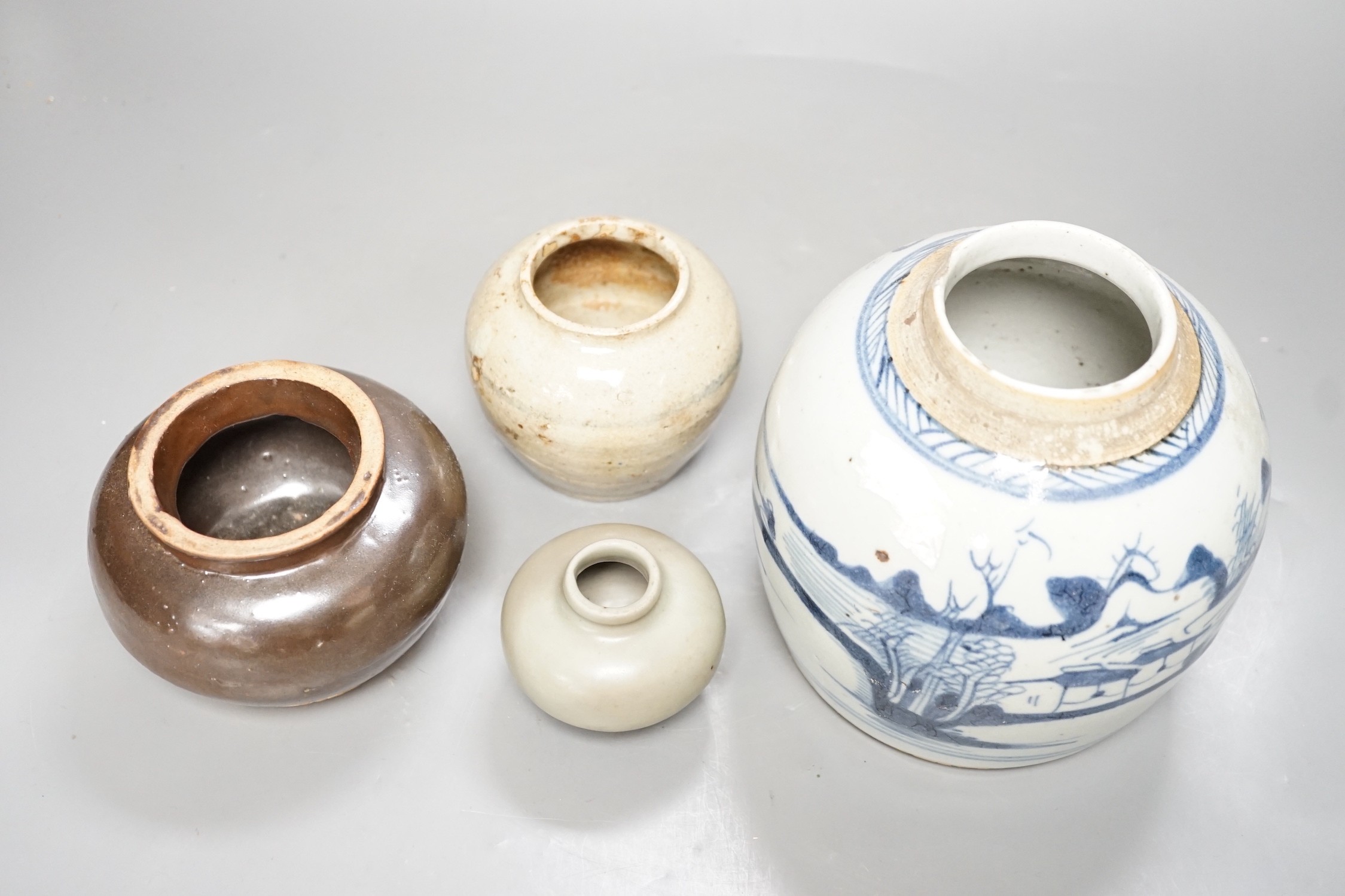 A Chinese celadon jarlet, Yuan-Ming Dynasty, two provincial stoneware jars and a 19th century Chinese provincial blue and white jar, tallest 16cm